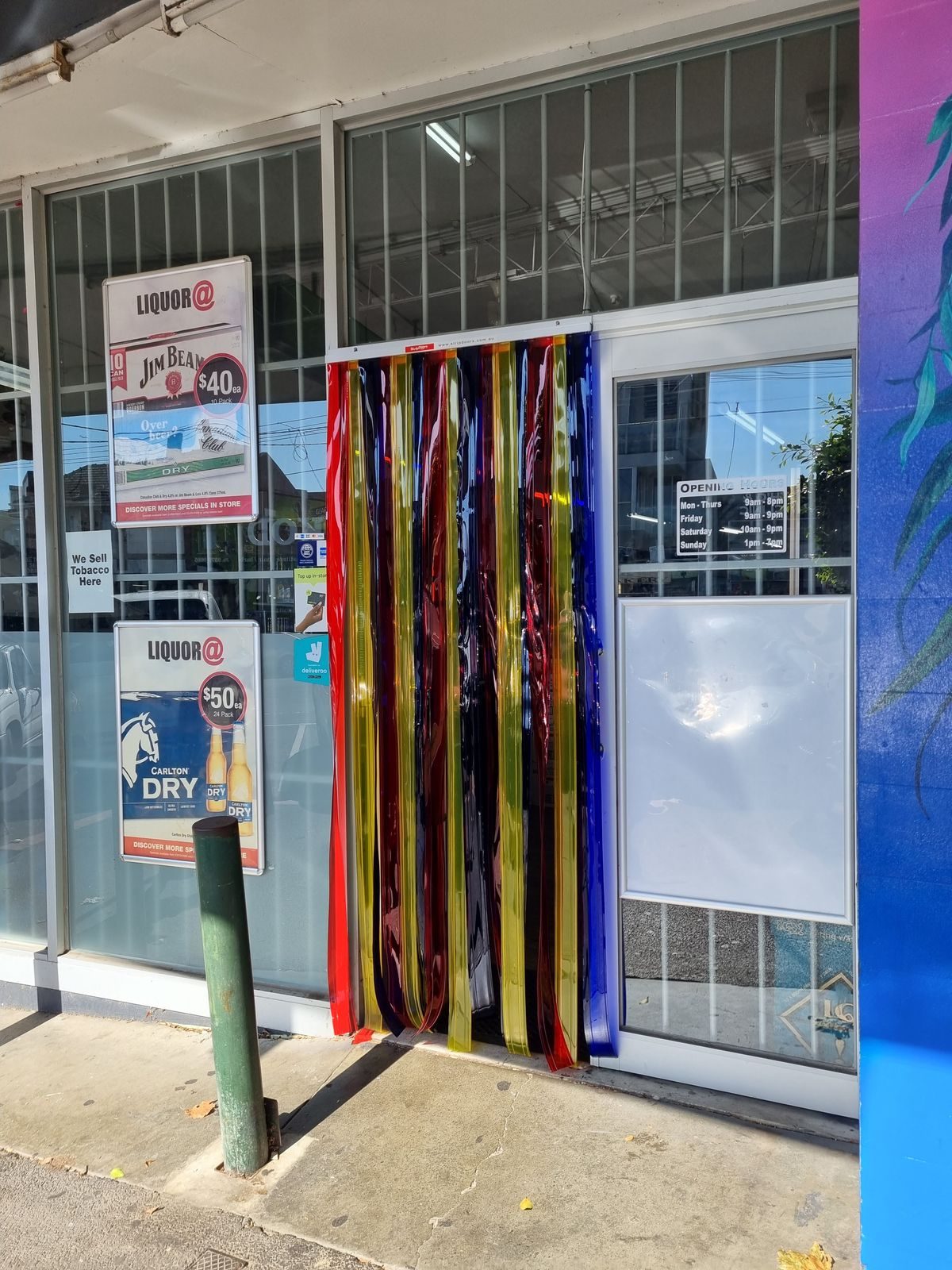 Multicoloured PVC strip curtain on the entrance of a bottle shop