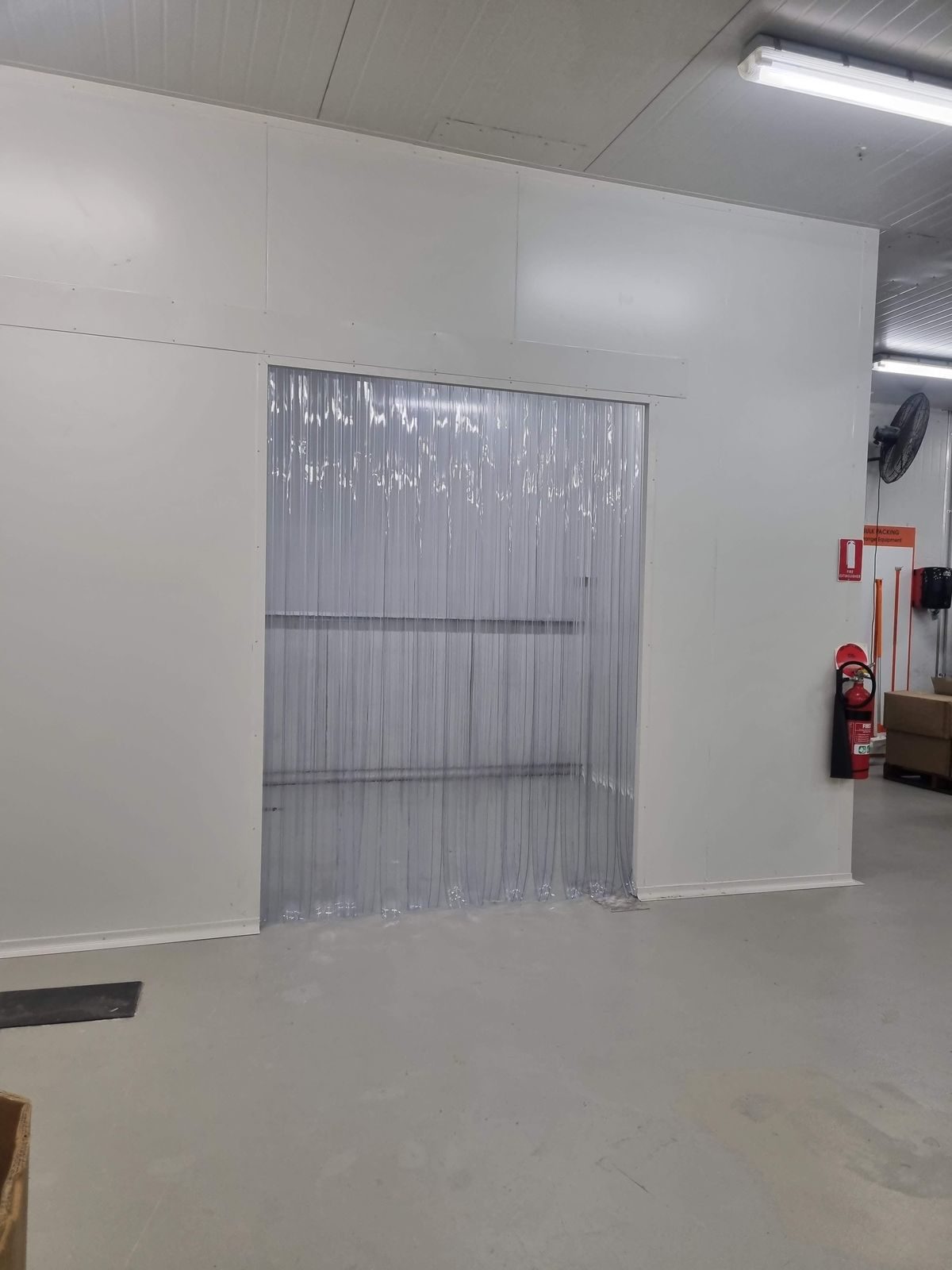 Clear PVC strip curtain fitted to a chiller room doorway in a food facility