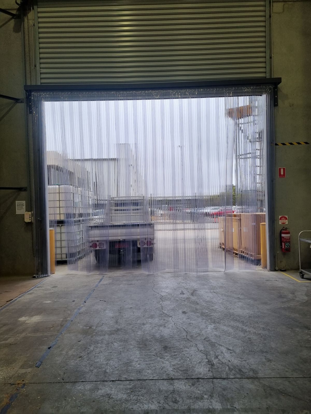 Clear PVC strip curtain on a despatch dock opening onto a hardstand