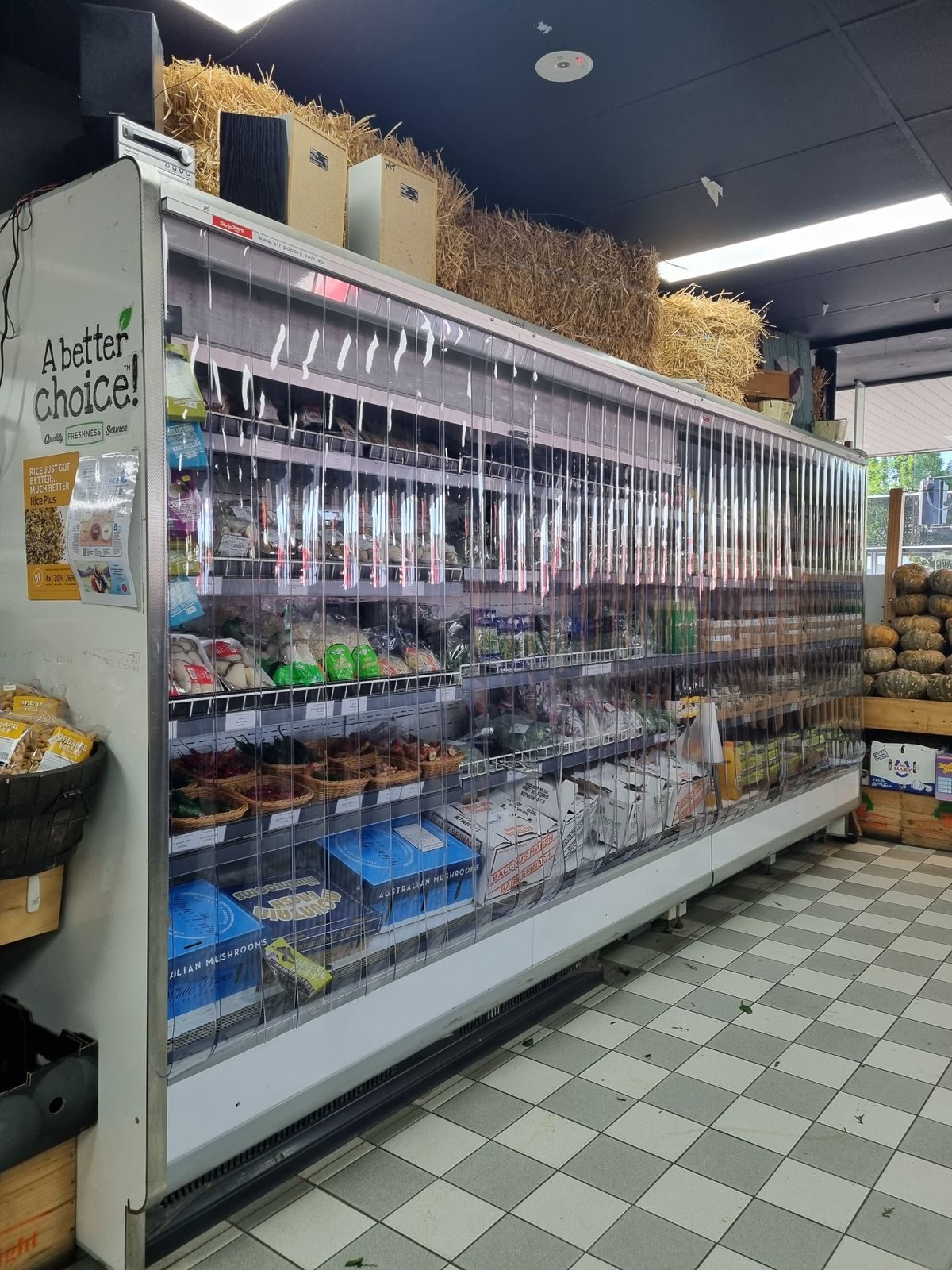 Night covers on a refrigerated produce display cabinet in a grocery store