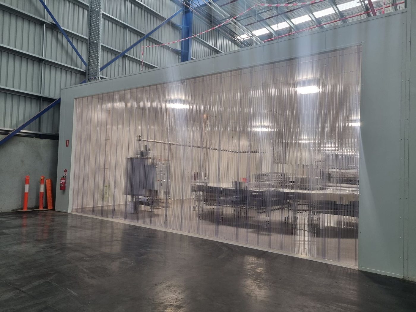 Clear PVC strip curtain running the full width of a food production area